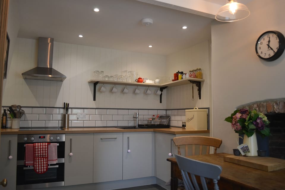 Spotlights over the kitchen and vintage lighting for the dining area.