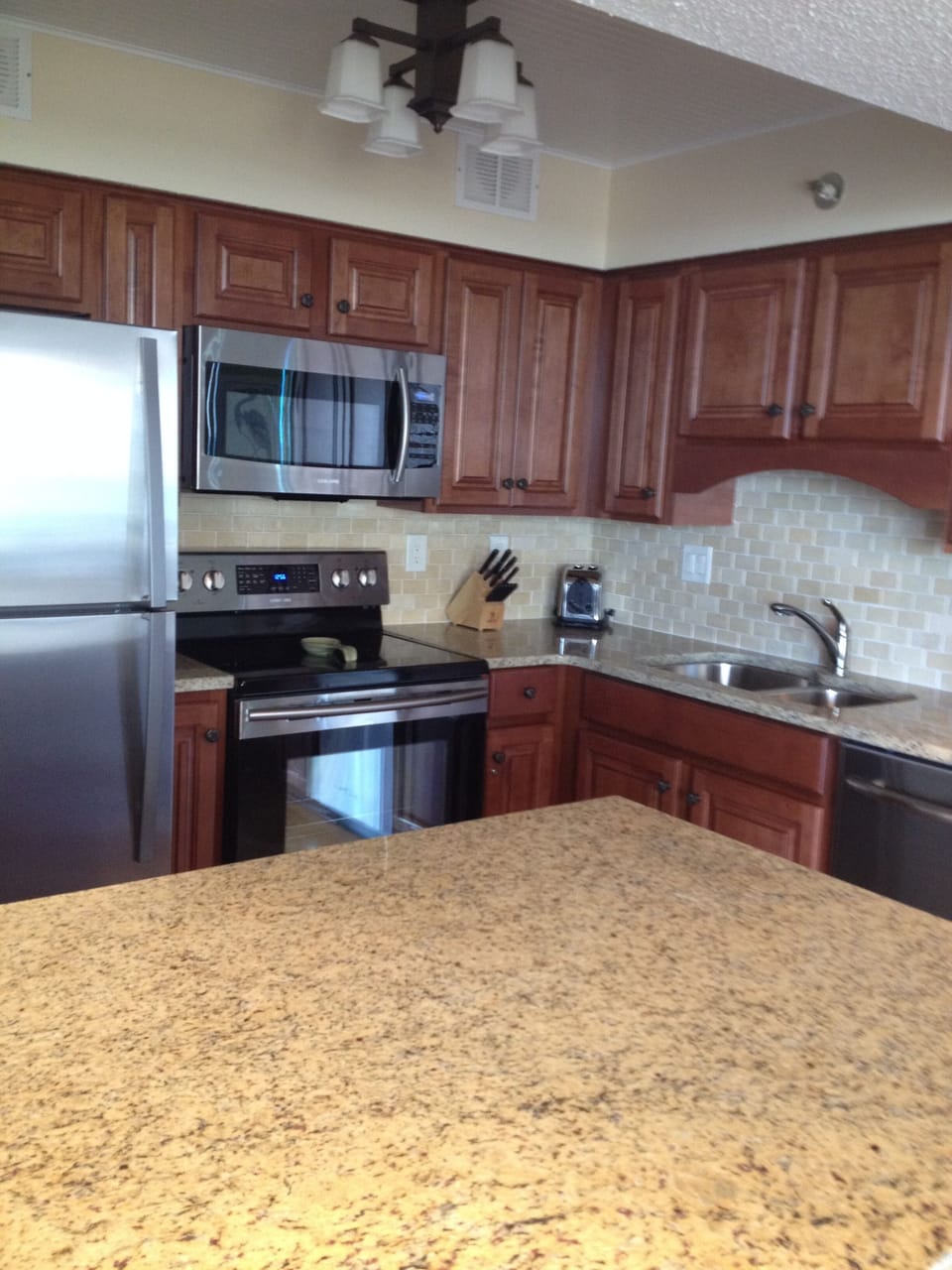 View of the kitchen, granite counter tops and stainless appliances