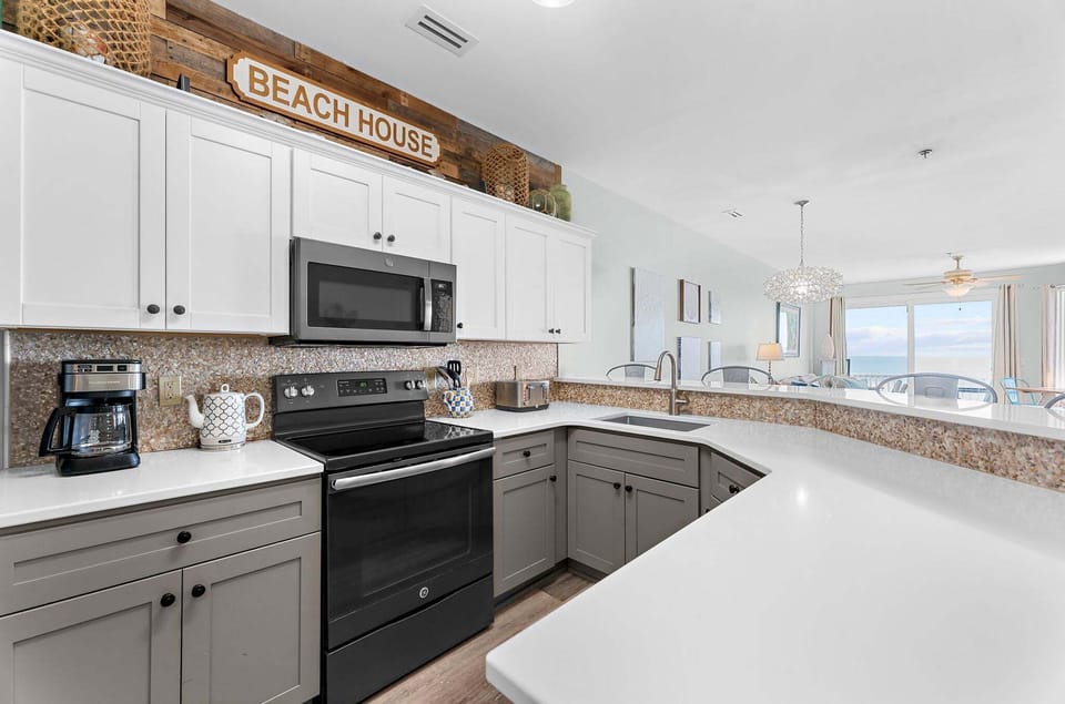 The kitchen boasts sleek stainless steel appliances, offering both style and functionality.