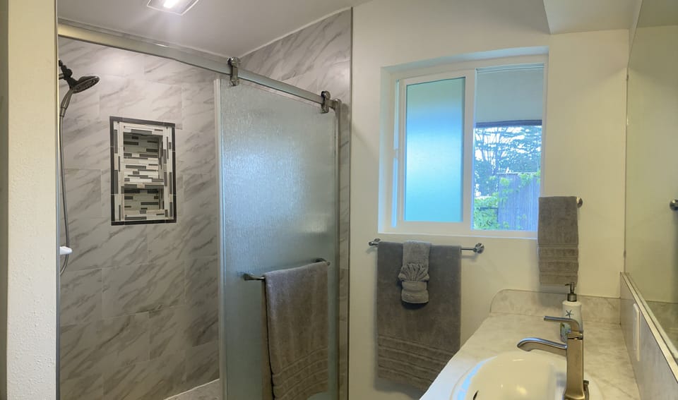 Master Bathroom with dual head tile shower and two sinks