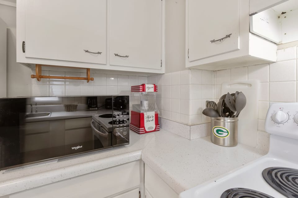 Microwave and popcorn machine in the kitchen.