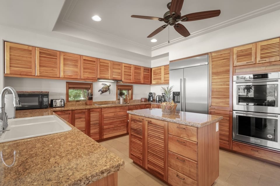 Elegant gourmet modern kitchen w/granite countertops and top tier appliances.