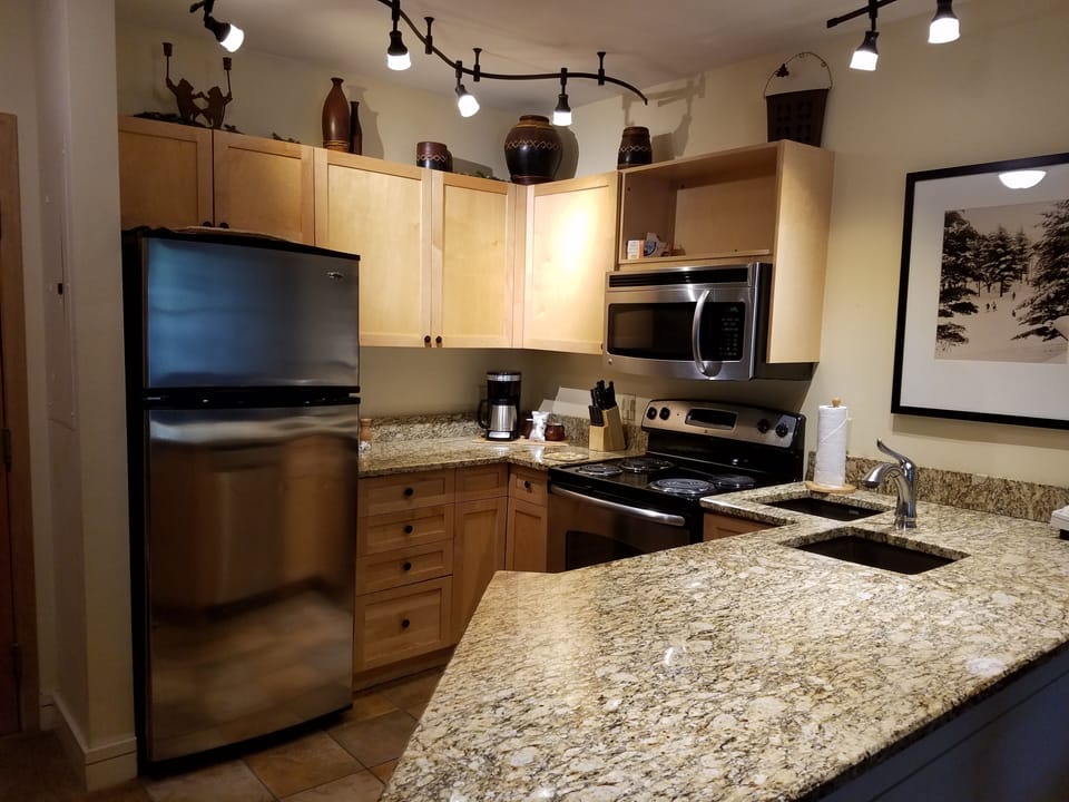 Kitchen updated w/ stainless steel appliances, granite counter tops & lighting.