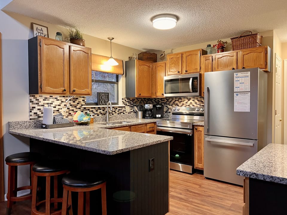 Wide view of kitchen with dining bar