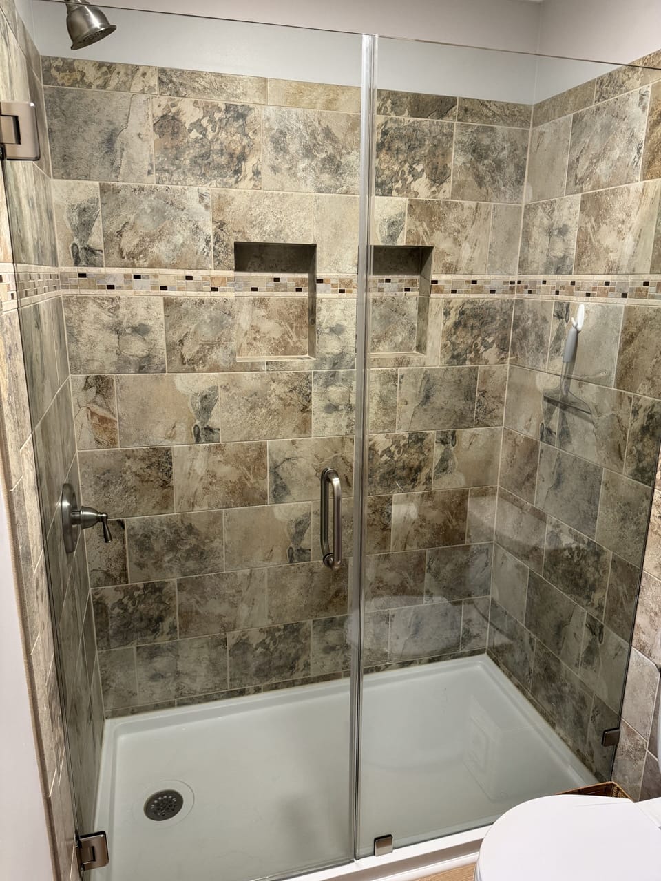 Lovely en-suite tile shower with glass