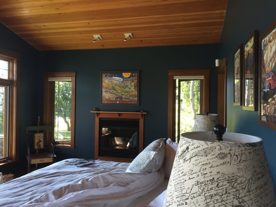 Brighter paint in master bedroom, king bed facing water & outdoor fireplace deck