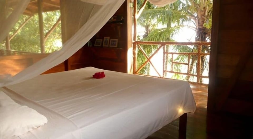 Master bedroom with gorgeous view of the sea, beach and mountains. 