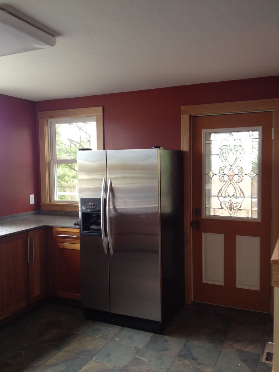 Refrigerator with water/ice maker. Door out to deck.