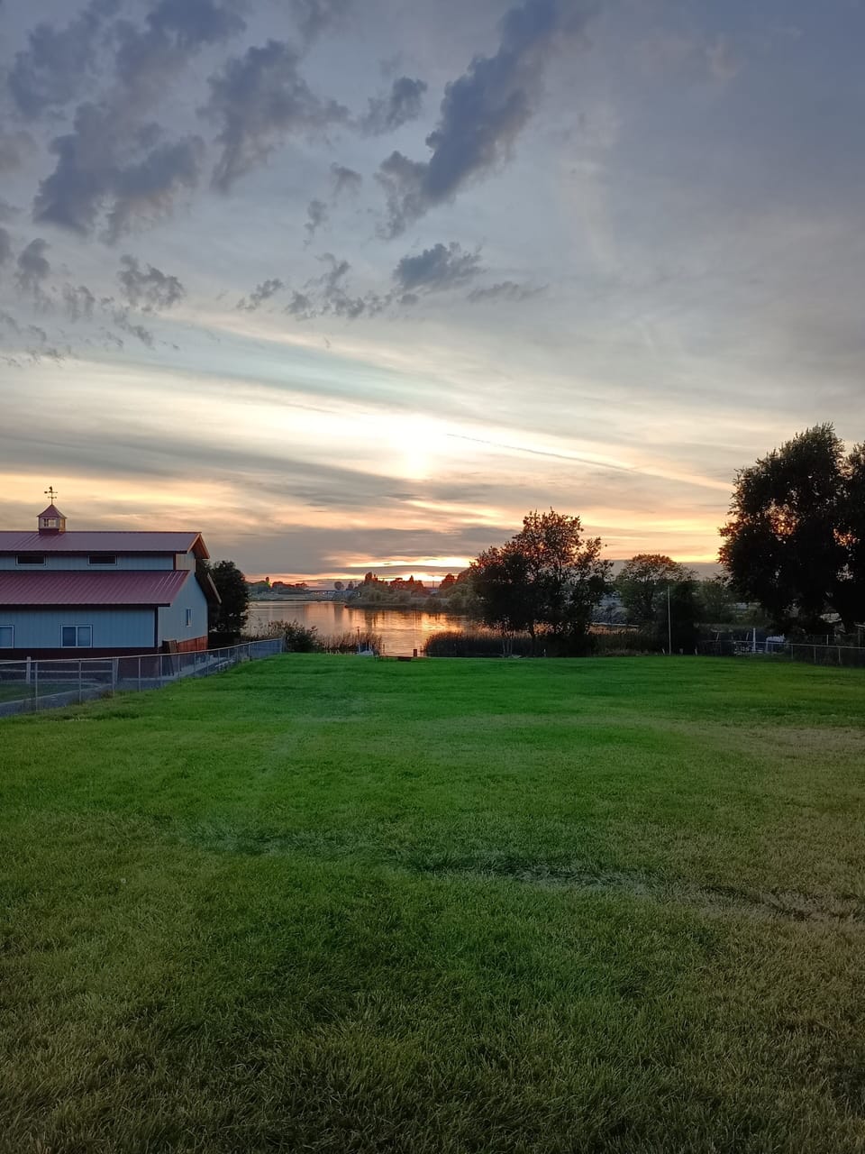 Huge fenced lawn leading to the dock cove and waterfront.