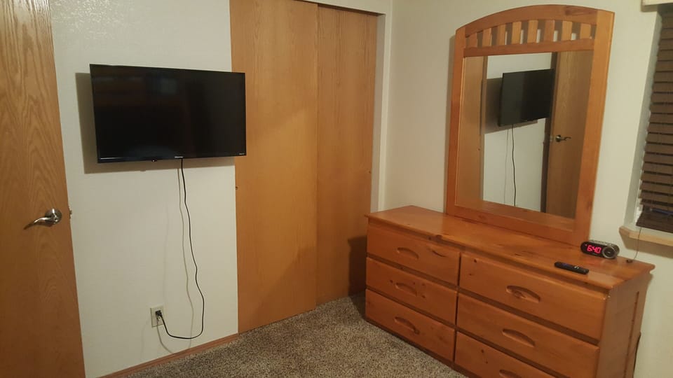 Queen lakeside room with a sleeper chair and streaming TV.