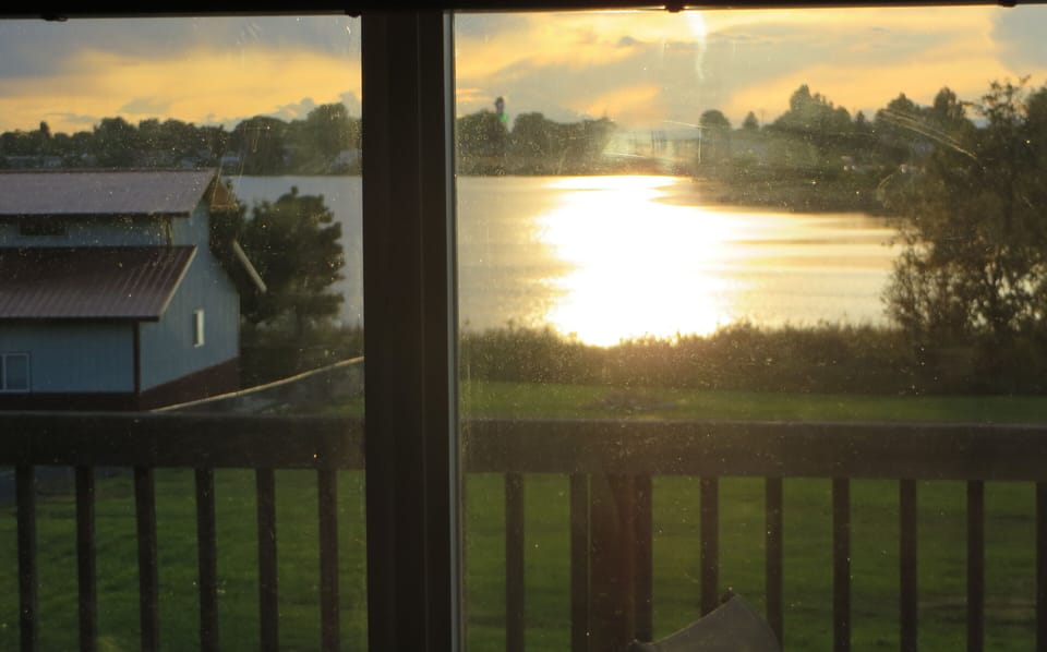 view of yard and lake from Living room window.