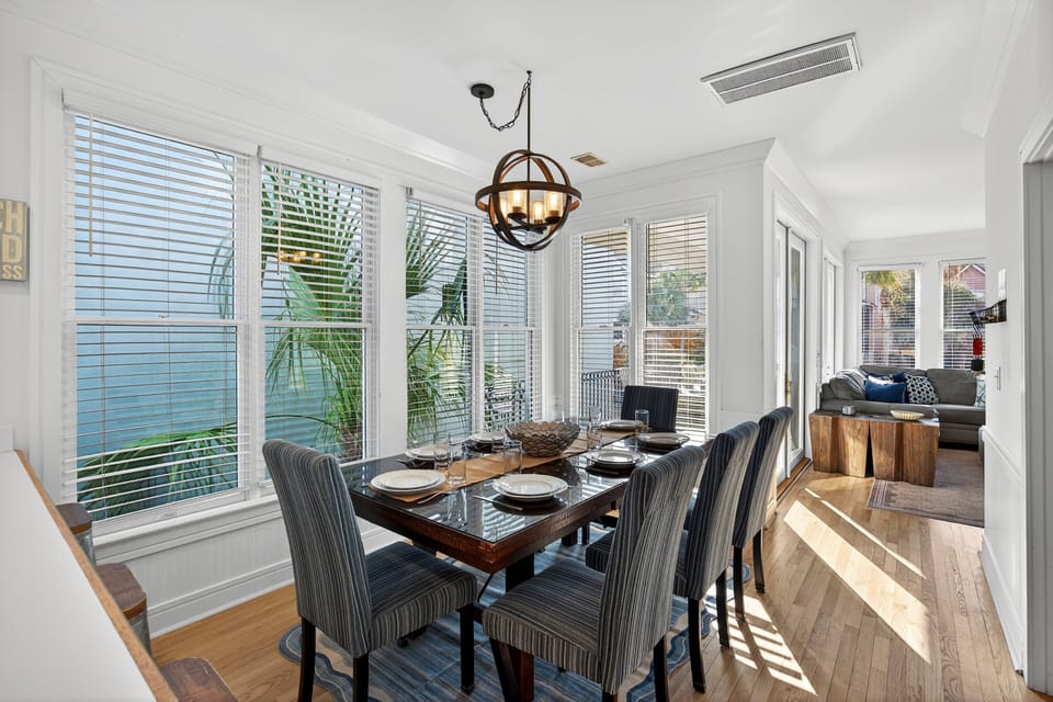 Modern dining room table with well stocked open concept kitchen.