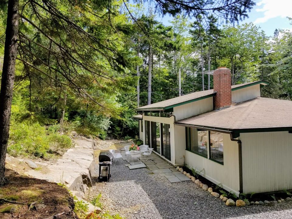 Quiet patio in the woods with BBQ grill and plenty of seating