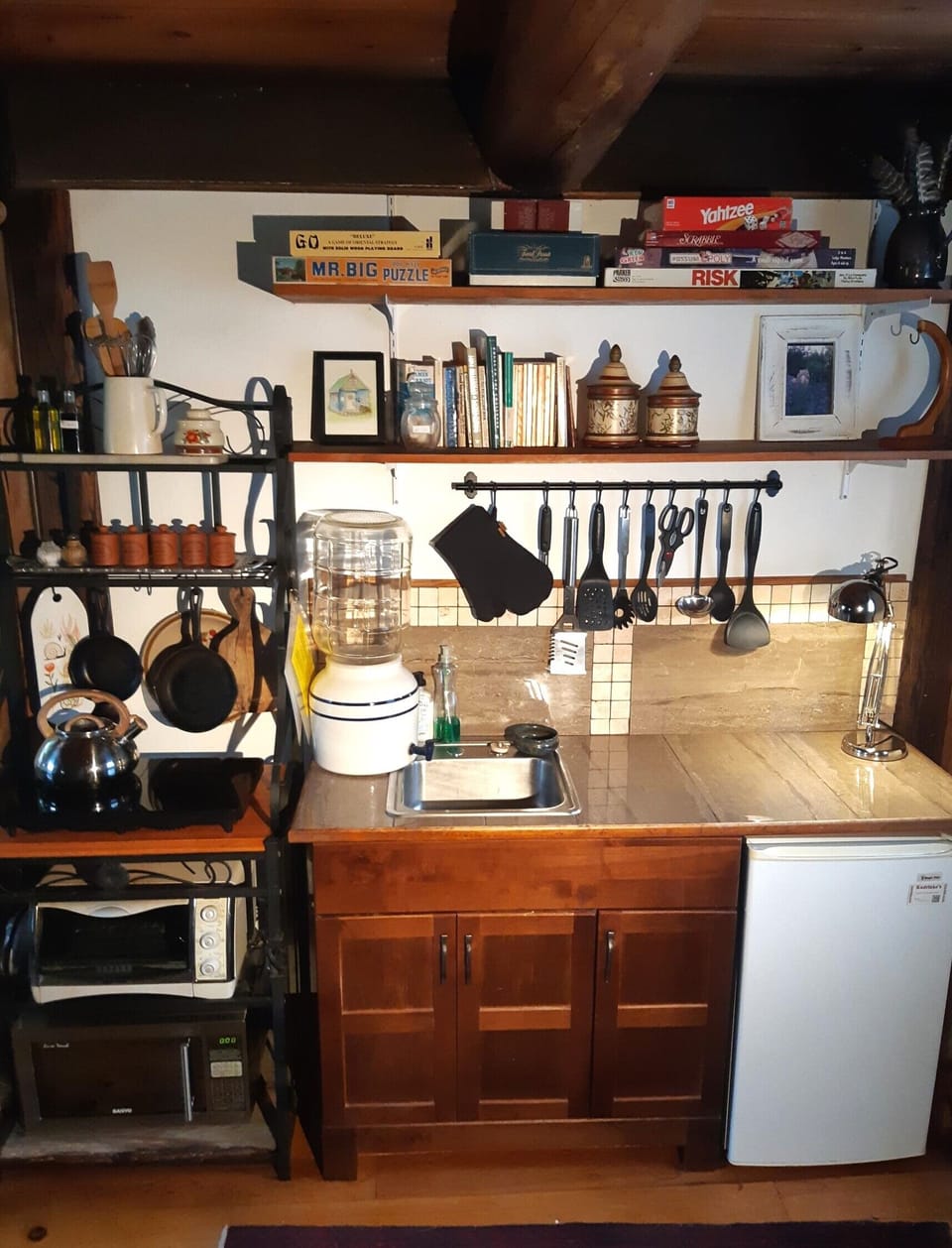Compact kitchenette with ceramic dispenser for potable water, grey water sink.