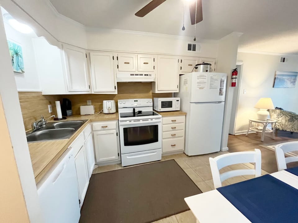 Fully equipped kitchen with newer microwave and refrigerator