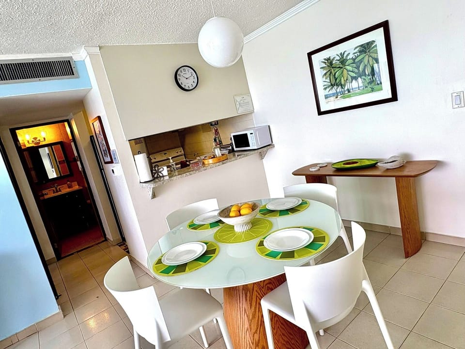 Modern dining set looking out to kitchen and bath entrance.
