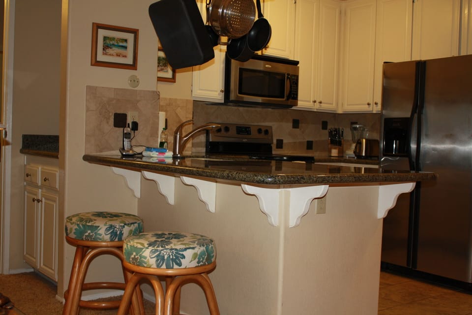 Fully stocked eat in kitchen with granite and stainless steel appliances. by GJT

