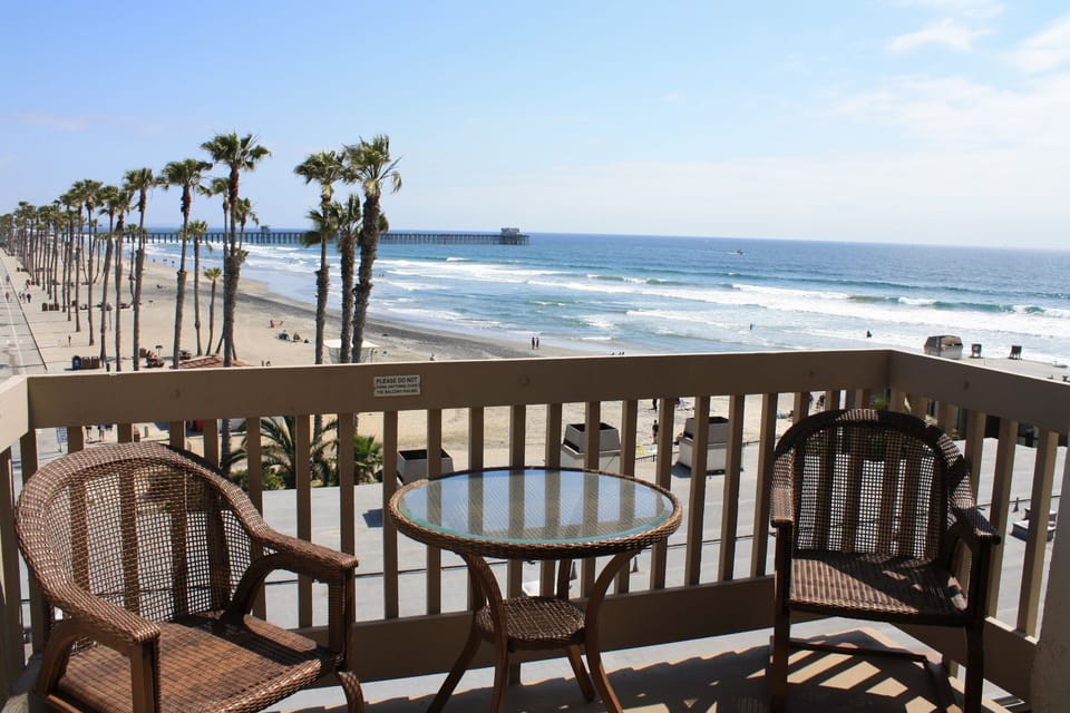 Lower level patio - sand, white water and pier view - facing southwest. by GJT
