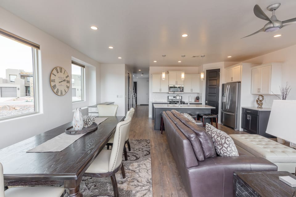 Dining Room - The Kitchen and Dining Table can accommodate 10 adults and is stocked with pots, pans, baking sheets, mixing bowls, plates, bowls, cups, silverware, and a collection of cooking utensils.