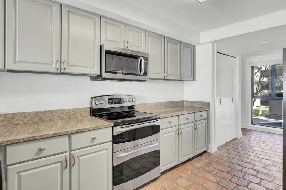 Kitchen is fully equipped and features stainless steel appliances.