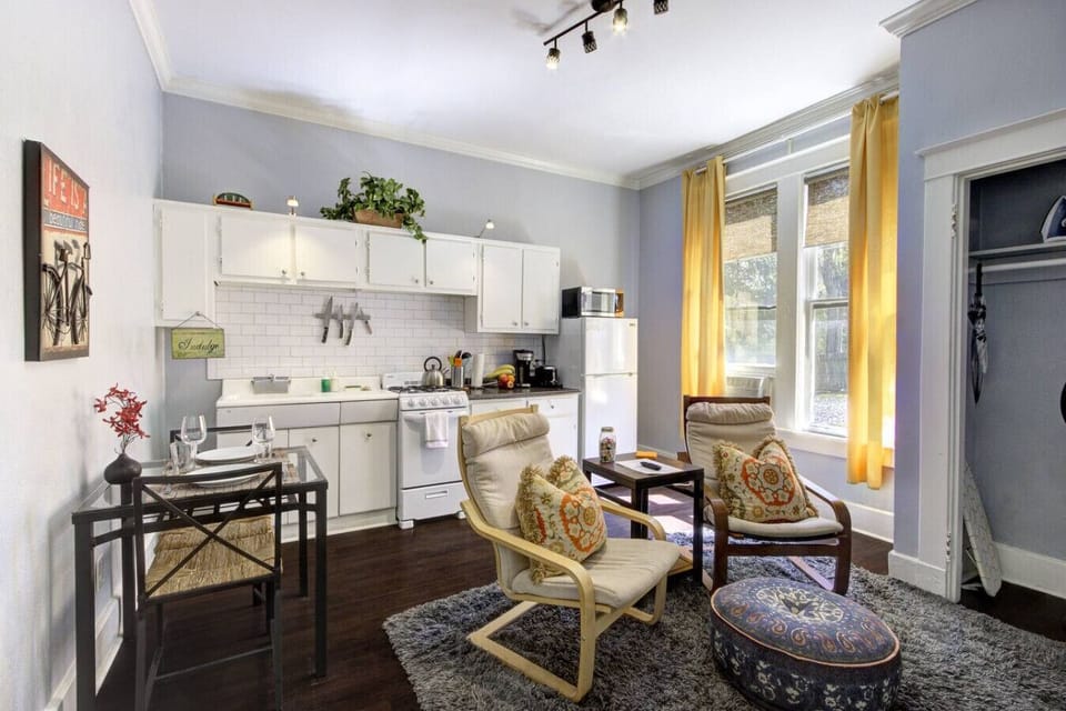 Smartly designed open-concept space combining kitchen, dining, and living areas—cozy, functional, and full of character.