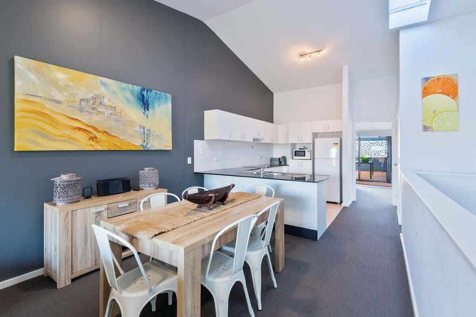 Open plan dining and kitchen in Greenfields apartment at Nautilus Jervis Bay holiday rentals.