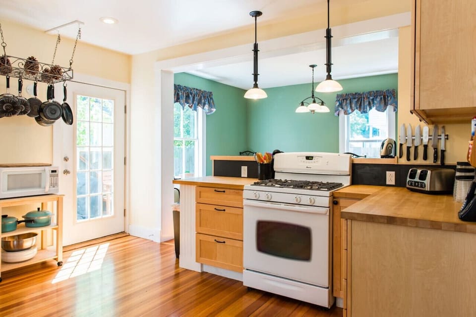 Bright sunny large kitchen with open floor plan to dining area and back porch.
