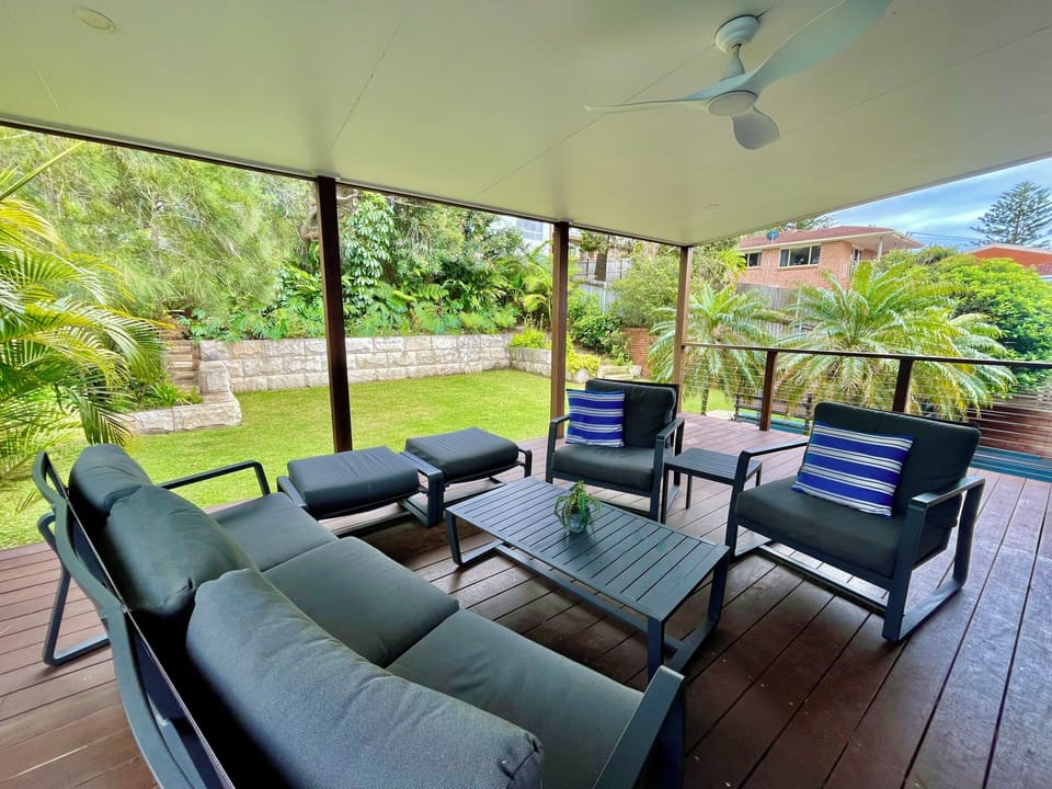 Back entertaining deck area with outdoor lounge and BBQ overlooking garden