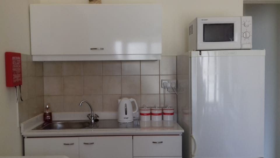 Kitchenette with provided tea, coffee,  bottled water, fresh milk upon arrival.