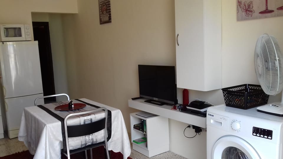 Right hand side upon entrance with some  appliances. TV is for DVD use only.