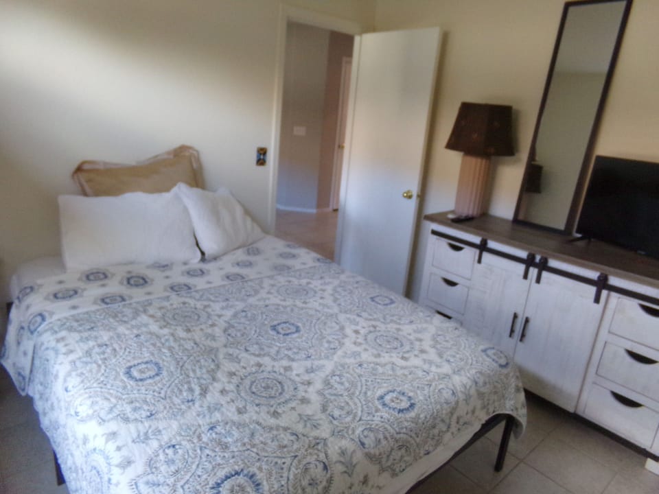B R  #2 has a ceiling fan,dresser, chair, lamps,mirror, adjustable privacy blind