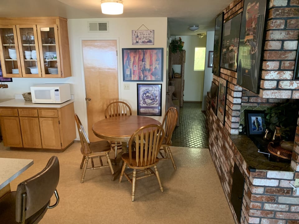 Part of the kitchen to front door. High stools up to the bar & dining table.