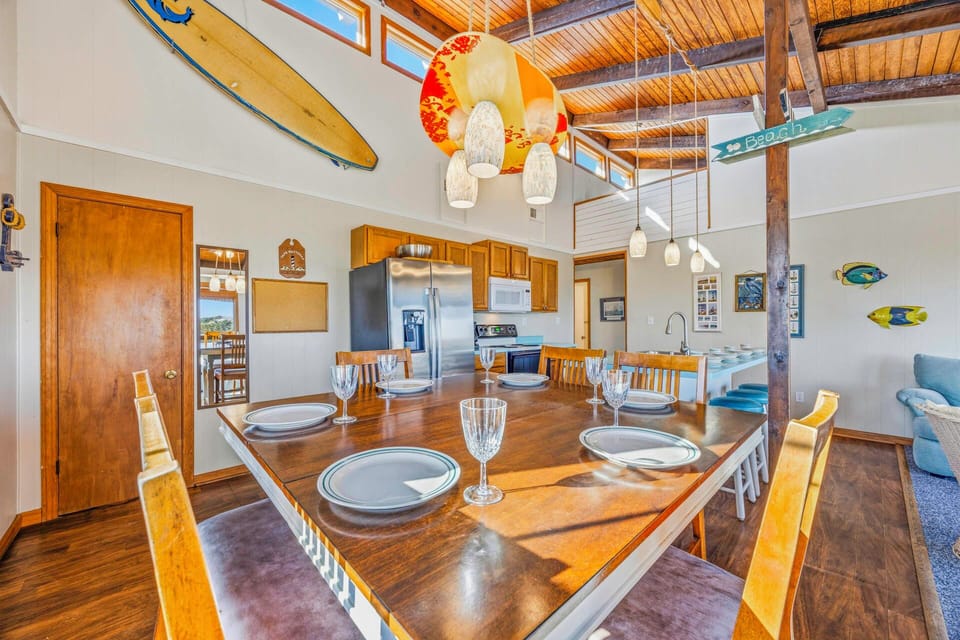Gather around your spacious dining table with stunning exposed beam ceilings and beach-inspired decor for memorable meals together.