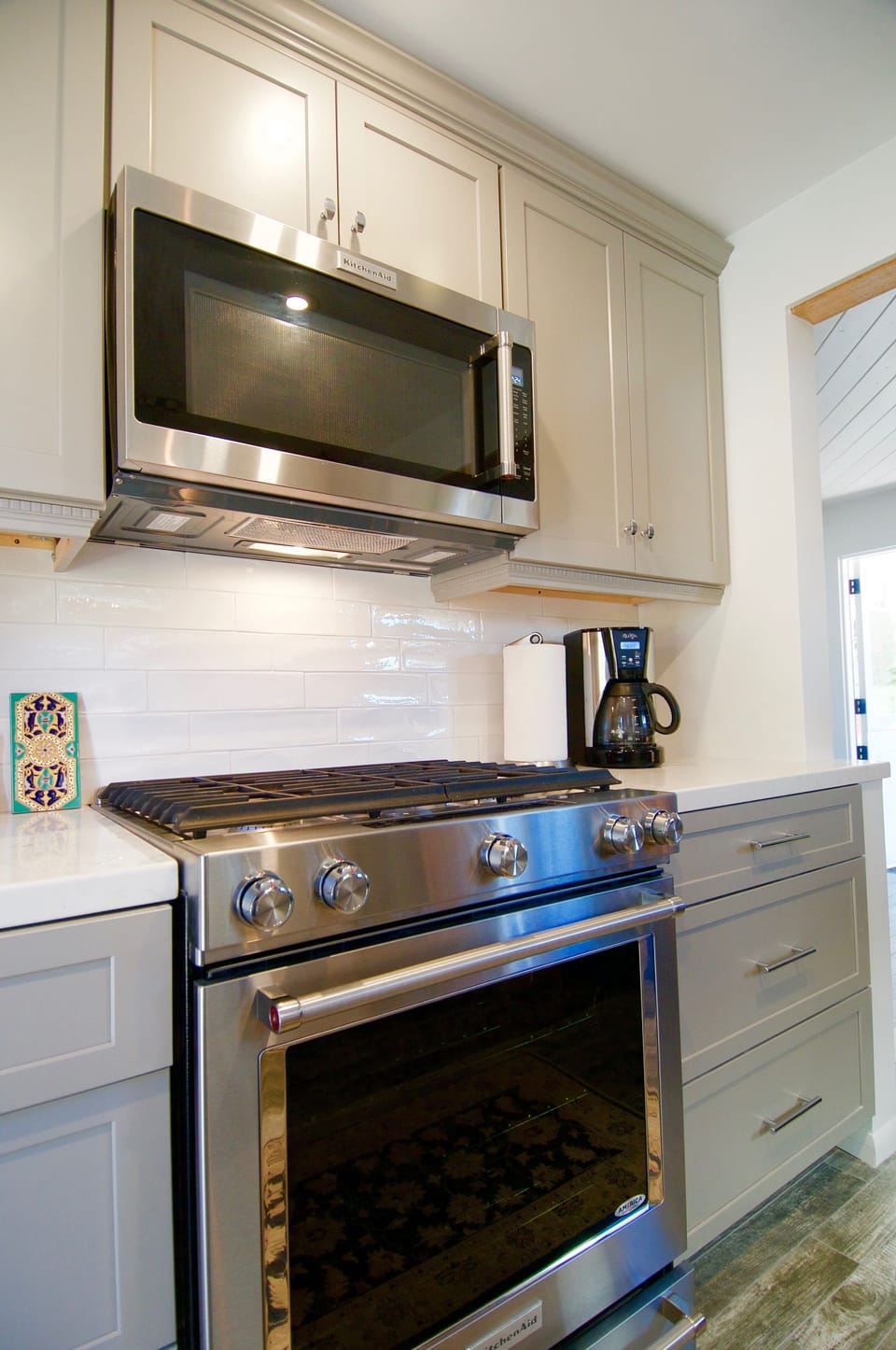 Gray shaker cabinets and new Kitchen-aid  appliances.