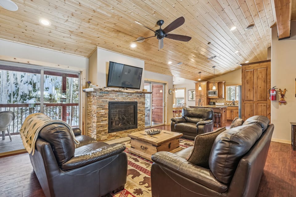 Living area looking into kitchen and to outside deck