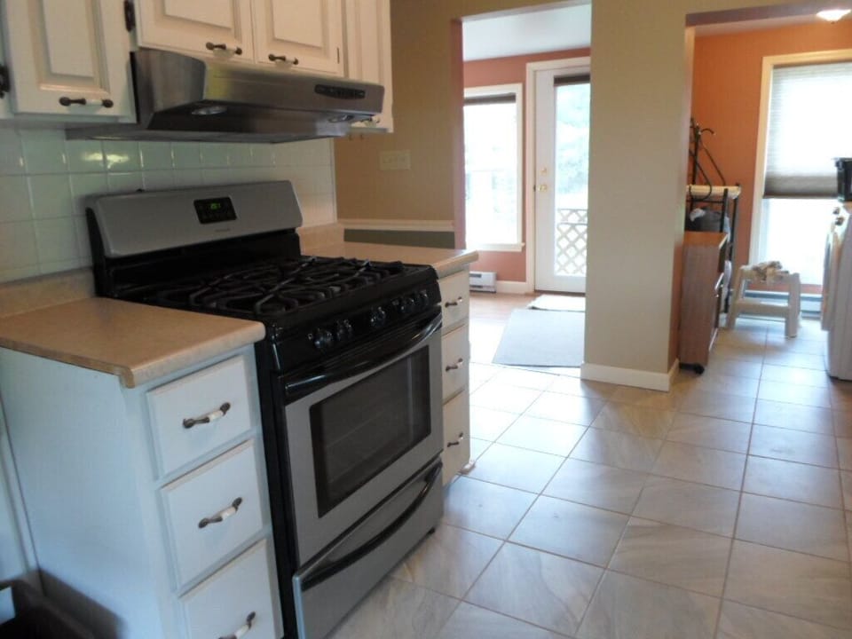 View from kitchen, sun room to the left, laundry room to right