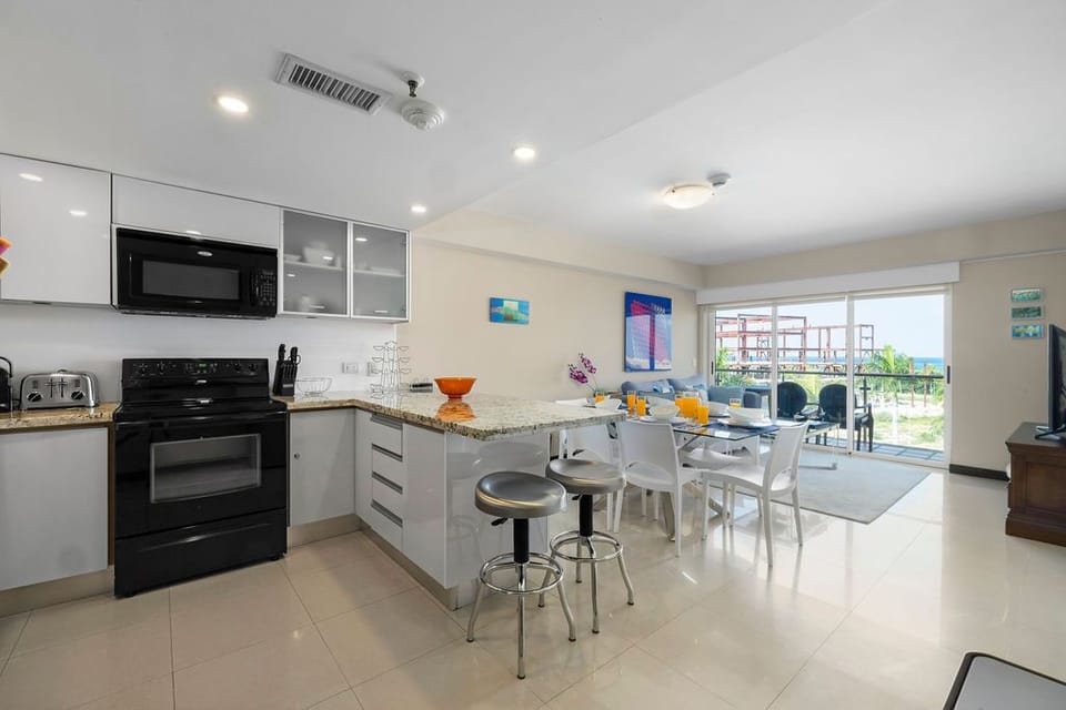 Your bright, open-plan kitchen and dining area flows into the living space, where natural light and ocean glimpses invite you to settle in and feel right at home.