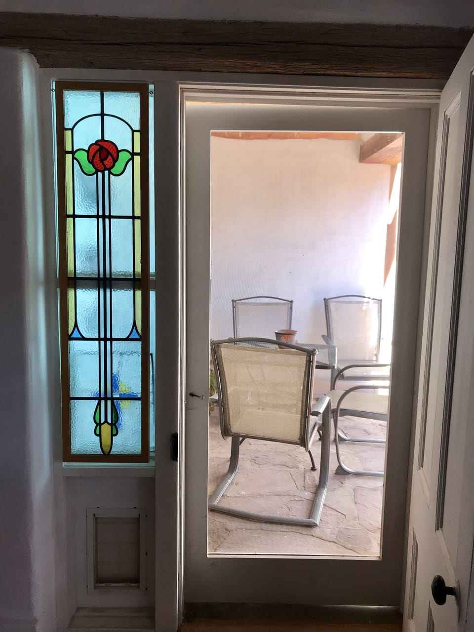 Door leading to a small covered patio.