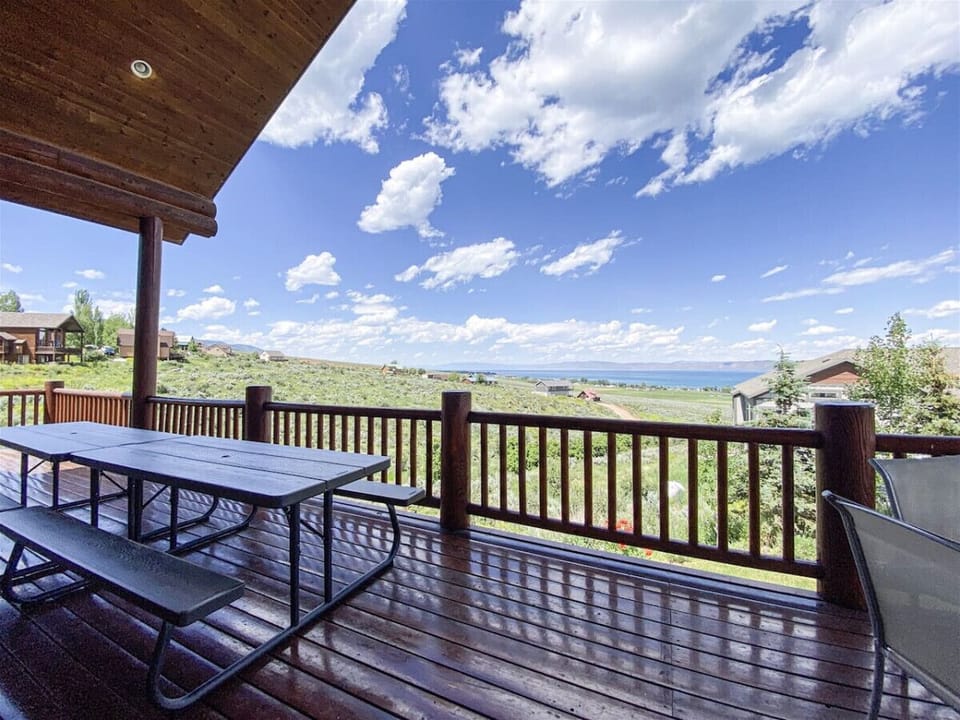Scenic deck with picnic table and lake views—ideal for outdoor meals and peaceful moments