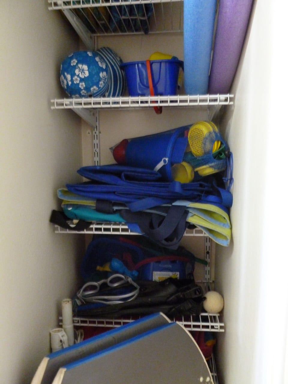 Beach closet for guest use: toys, boogie boards, chairs, umbrellas, coolers