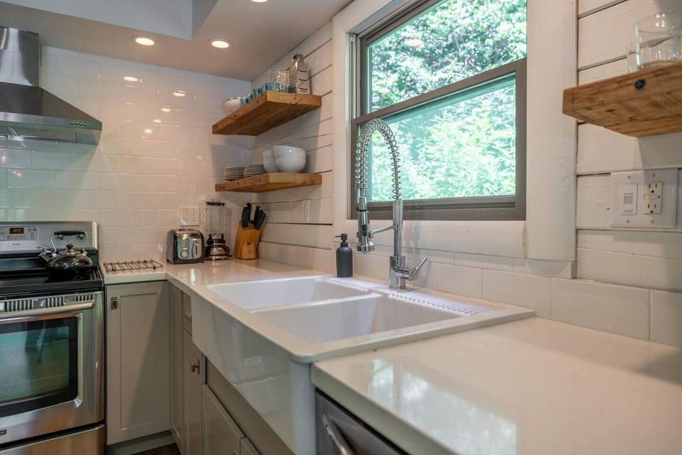 Another view of the kitchen, with window overlooking the forest beyond.