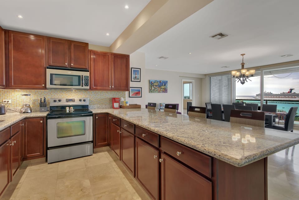 Beautiful kitchen overlooks huge sliding doors that open to the terrace.