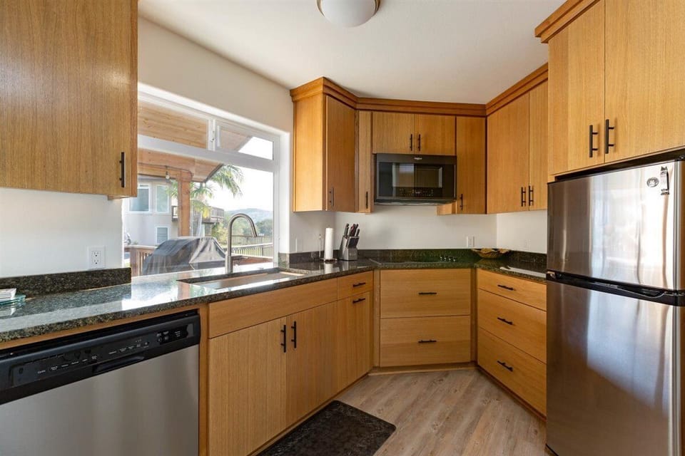 Kitchen features dishwasher, sink, stove, microwave/convection oven, and fridge