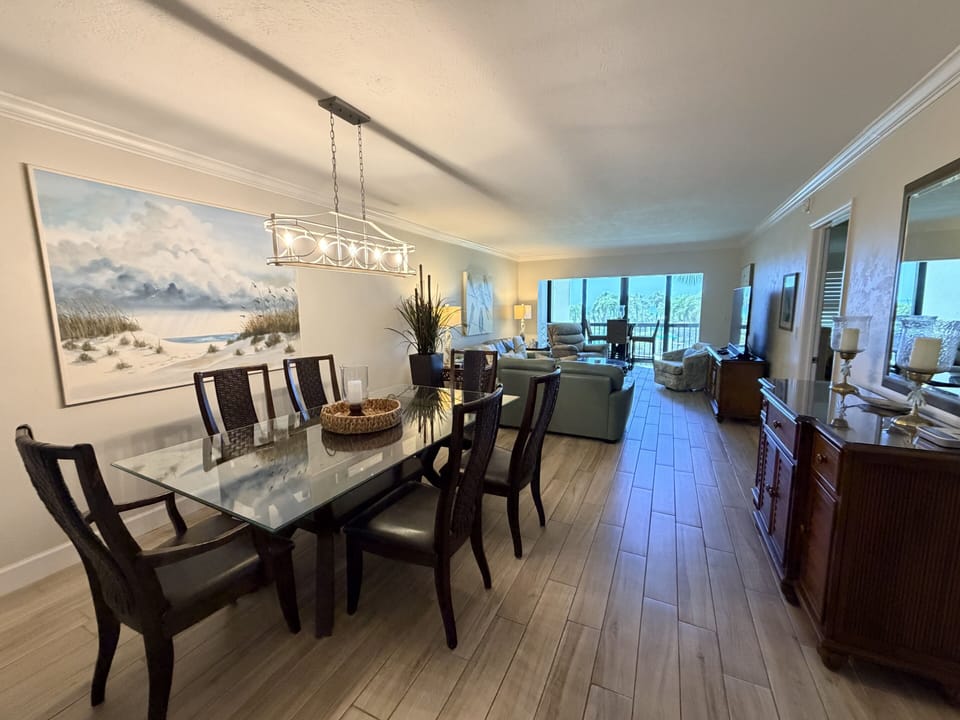 Gather around the elegant dining table with your favorite people, then unwind in the open-concept living area that flows seamlessly to your private balcony overlooking coastal beauty.