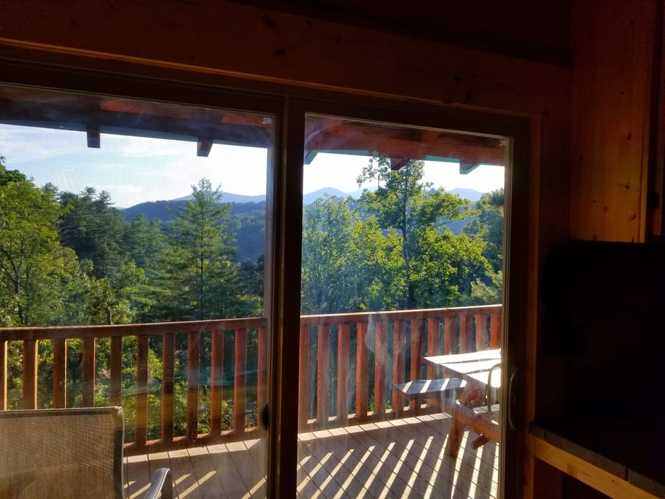 Living room view. Wrap around deck overlooks river and mountain views