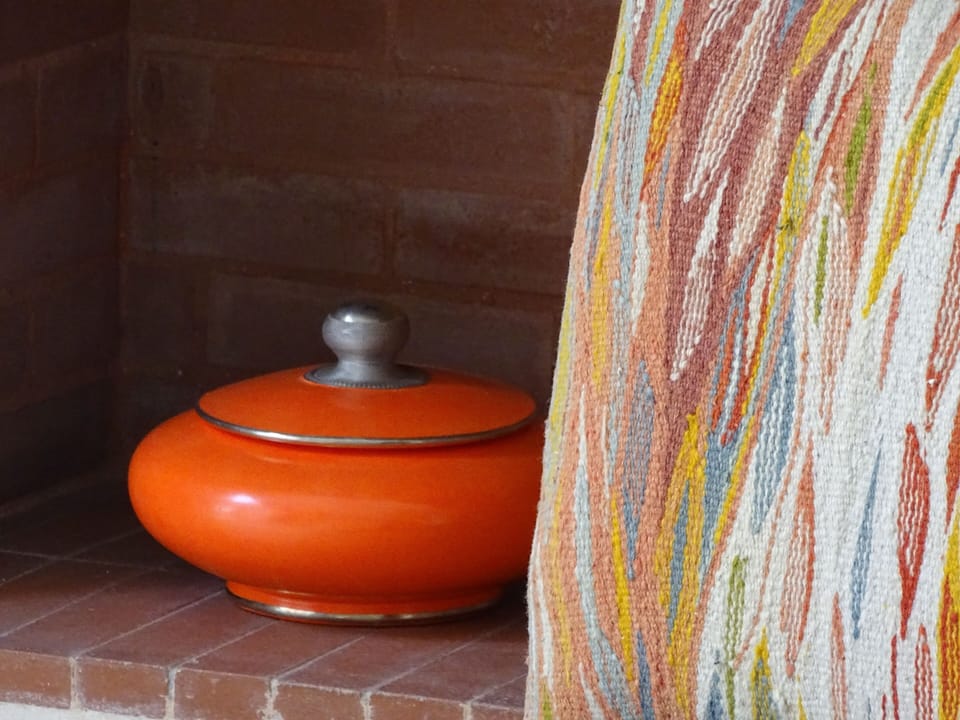Moroccan woven fabric used to upholster chair with ceramic bowl.