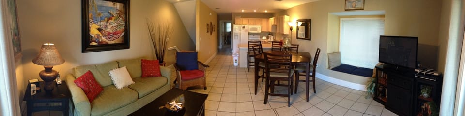 Panoramic view of living room, dining area and kitchen from main deck
