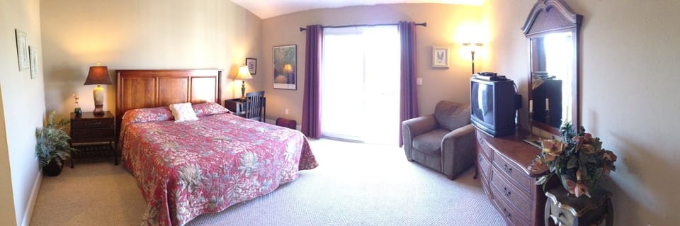 Panoramic view of master bedroom from top of stairs