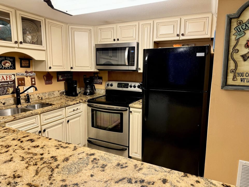 A fully stocked kitchen awaits - bowls, plates, cups, silverware, everything!