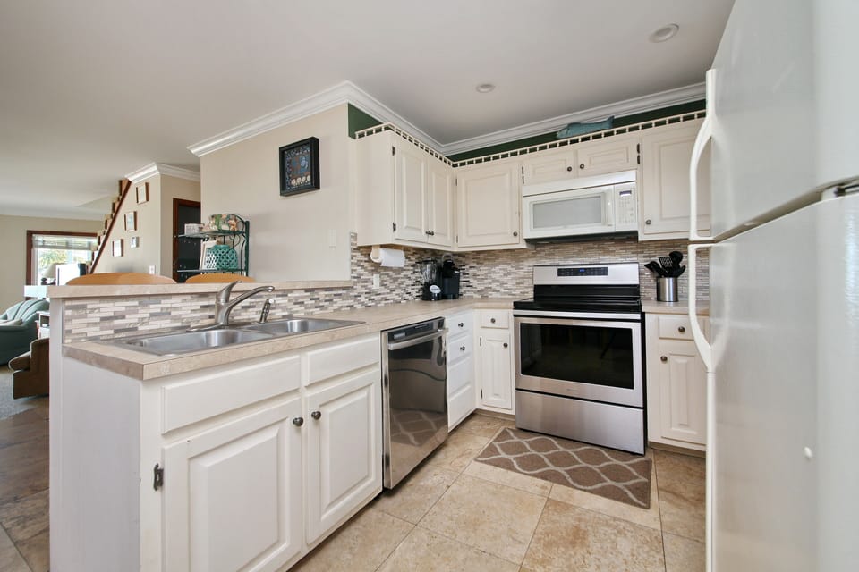 Kitchen with bar seating, open to living room